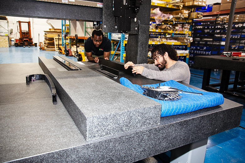 Thorlabs' employese working on a VideoMic system in our warehouse.