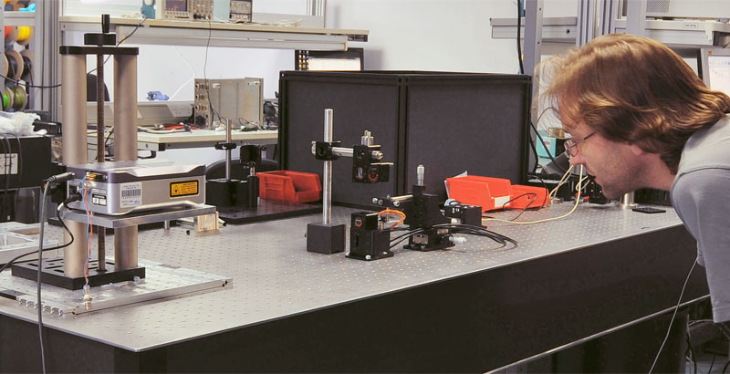 A mechanical engineer tests a prototype in the lab.